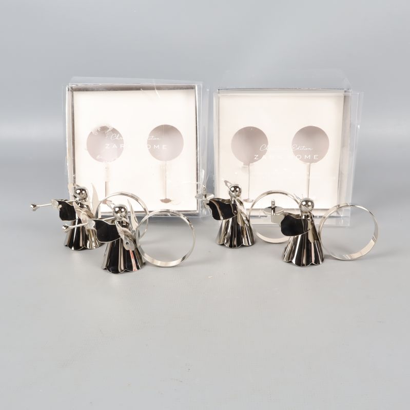 Fyra silvriga ängel-servettringar med originalförpackning