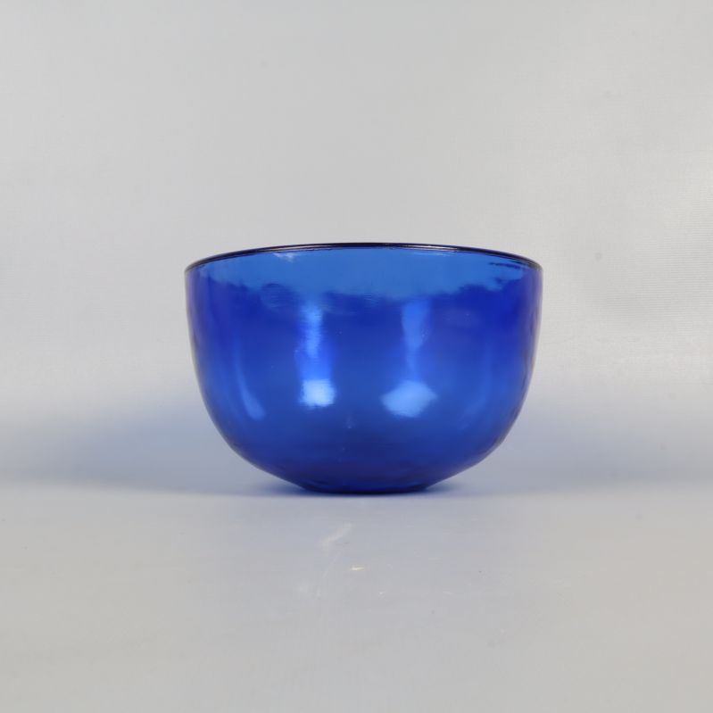 Blå glasskål sedd rakt framifrån mot ljus bakgrund