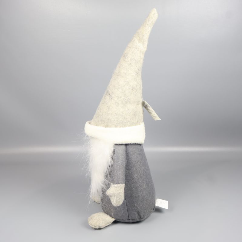 Tomtefigur visad i profil med armar och spetsig mössa