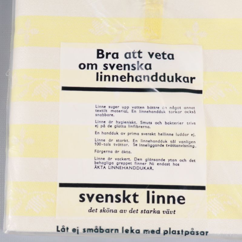 Närbild på instruktioner och fakta om linnehanddukar