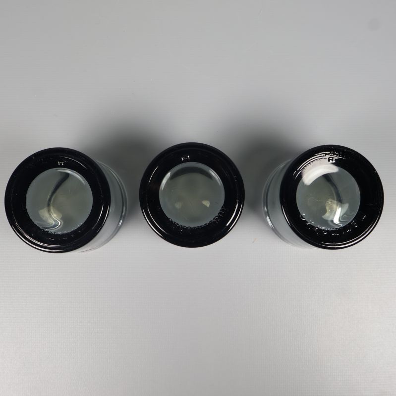 Tre Iittala ljuslyktor sedda underifrån