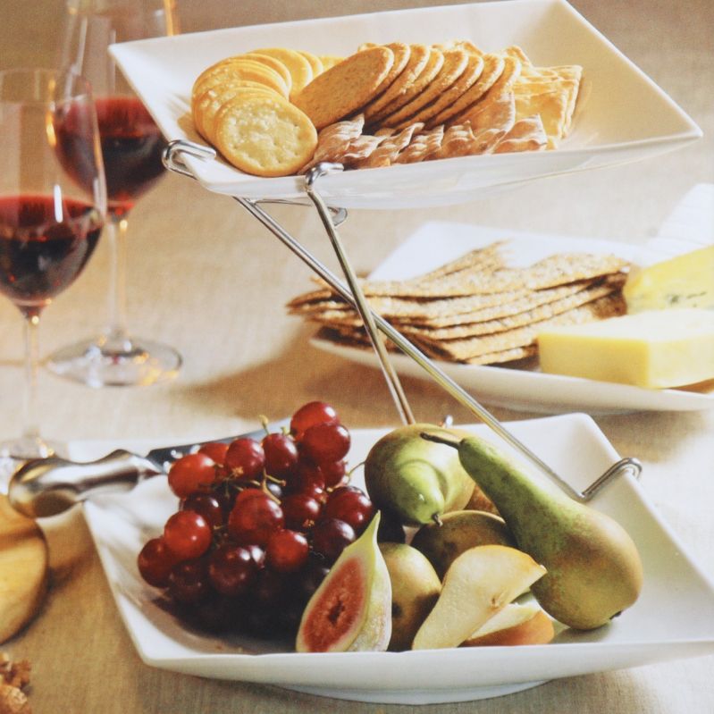 Tvåvåningsfat med frukt och kex, lyxigt dukat bord