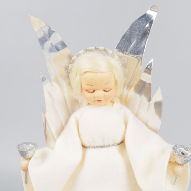 Närbild på ängelspeldosans ansikte och vingar