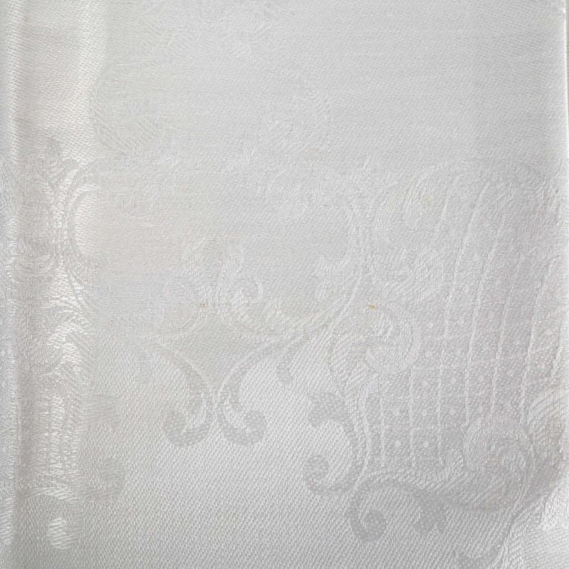 Närbild av det invävda mönstret i vit servett