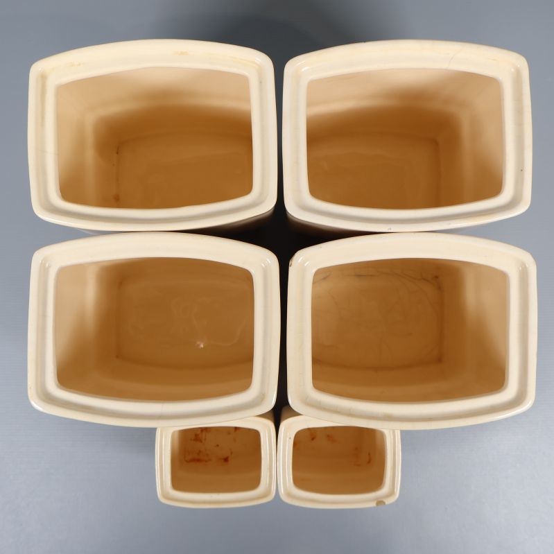 Sex öppna förvaringsburkar sedda ovanifrån, insidan synlig