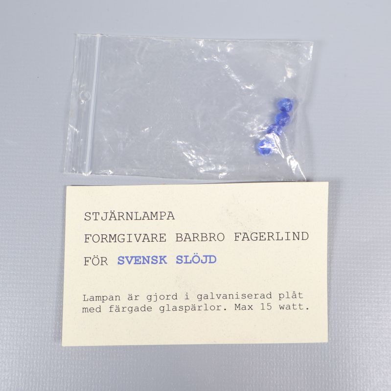 Informationslapp om stjärnlampa och designer Barbro Fagerlind