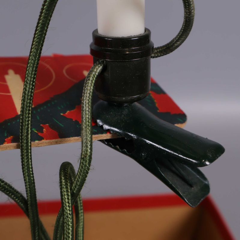 Detalj av grön klämma för fastsättning av julgransljus