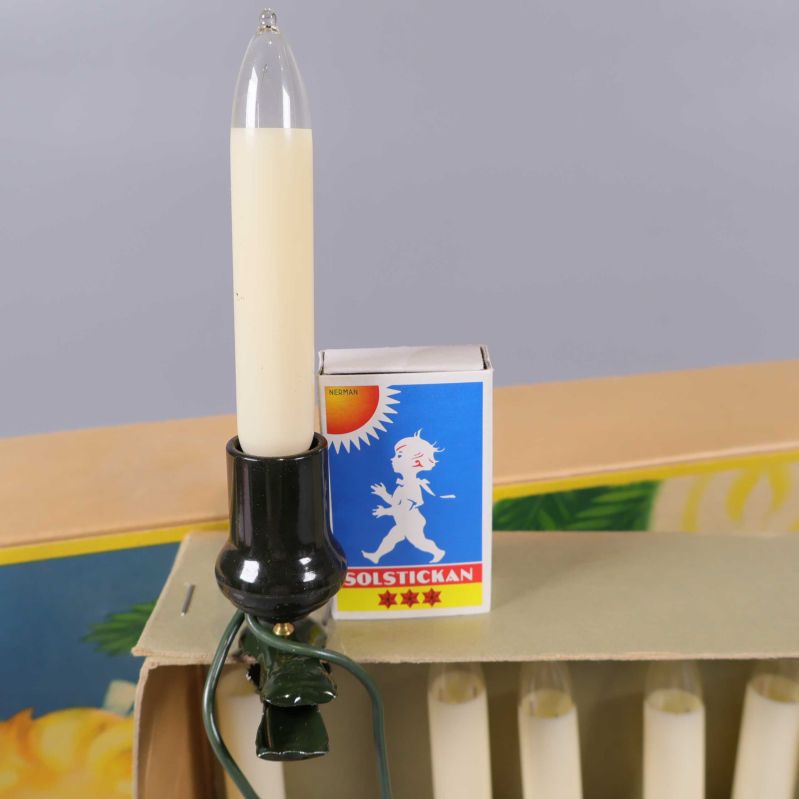 Närbild på ett ljus och tändsticksask sida vid sida