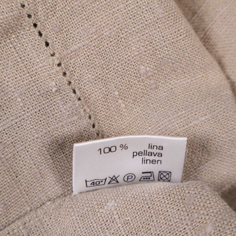 Materialetikett med text 100 % linne