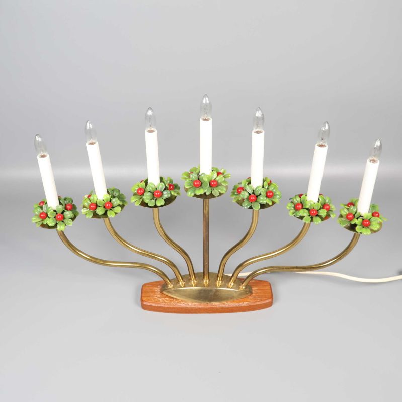 Sjuarmad elektrisk ljusstake med gröna och röda kransar på ljusen
