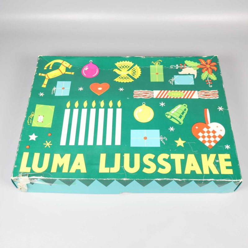 Originalkartong med texten Luma Ljusstake och färgglada julmotiv