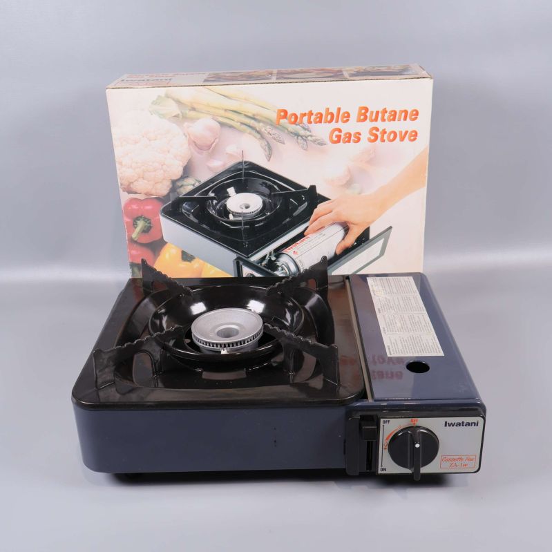 Portabel butan gasspis framför förpackning