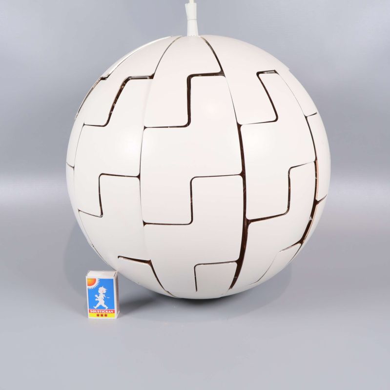 Taklampa placerad bredvid tändsticksask för storleksjämförelse