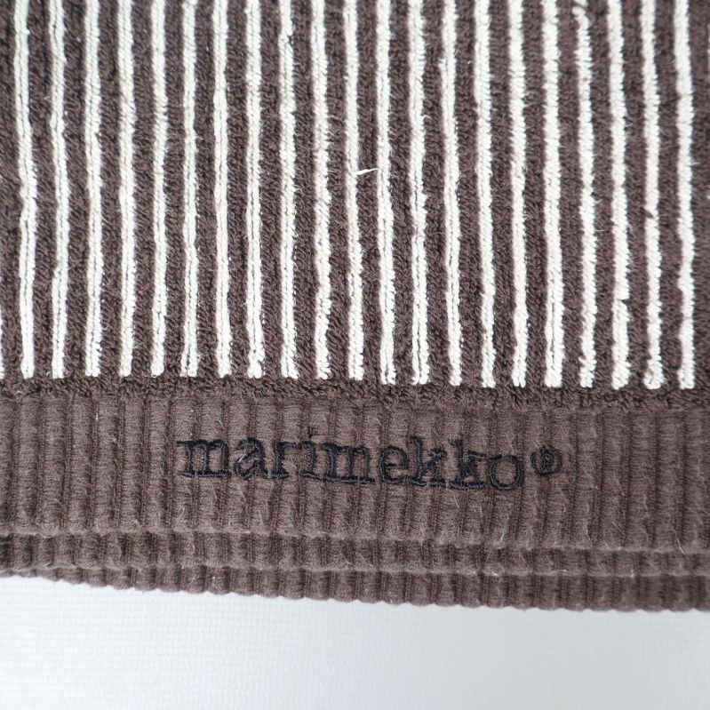 Närbild på broderad Marimekko-logga på handduk