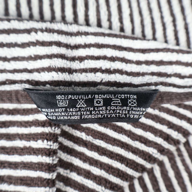 Materiallapp som visar 100% bomull i flera språk