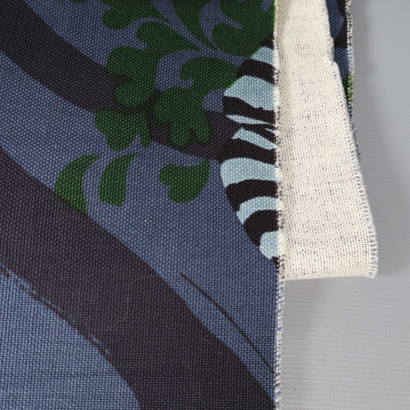 Närbild på gardin med grönt och vitt blomdetaljmönster