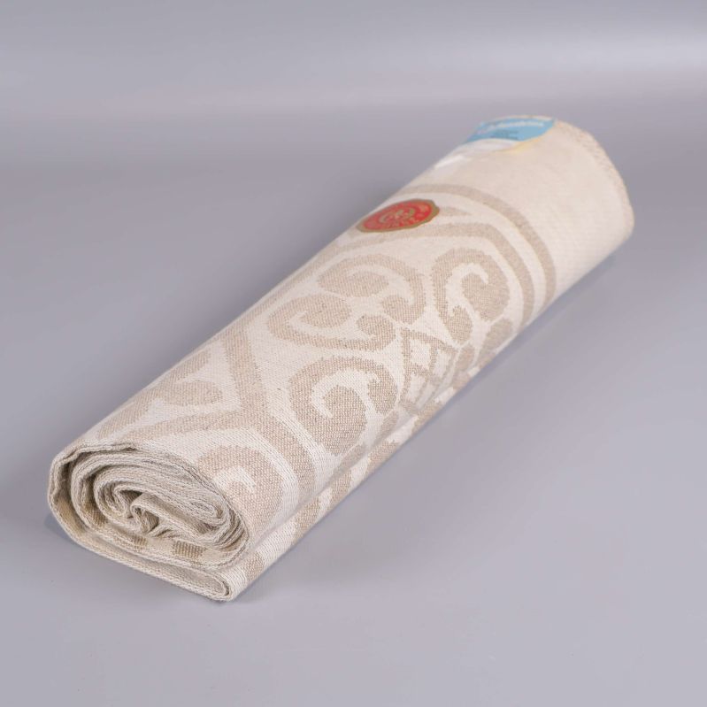 Sammansrullad mönstrad duk i beige toner