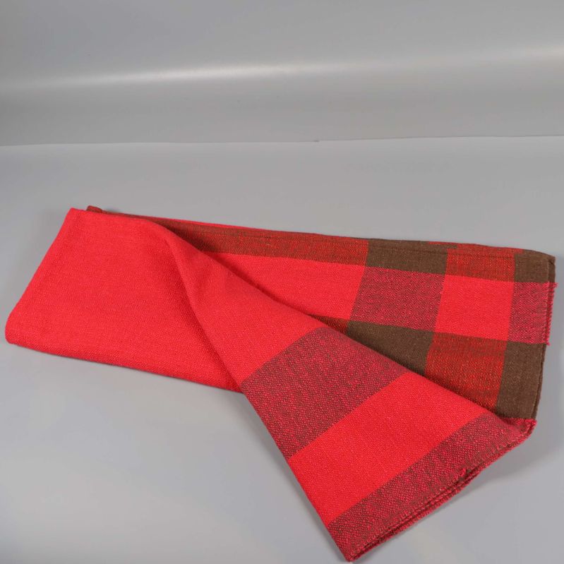 Rutig duk i rött och brunt delvis vikt