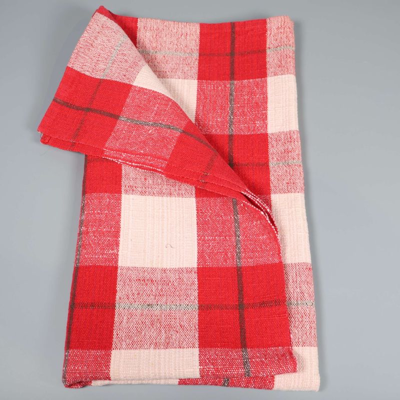 Rutig duk delvis vikt utlagd på grå bakgrund