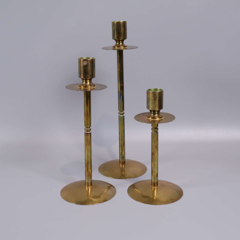 Tre mässingsljusstakar i olika höjder