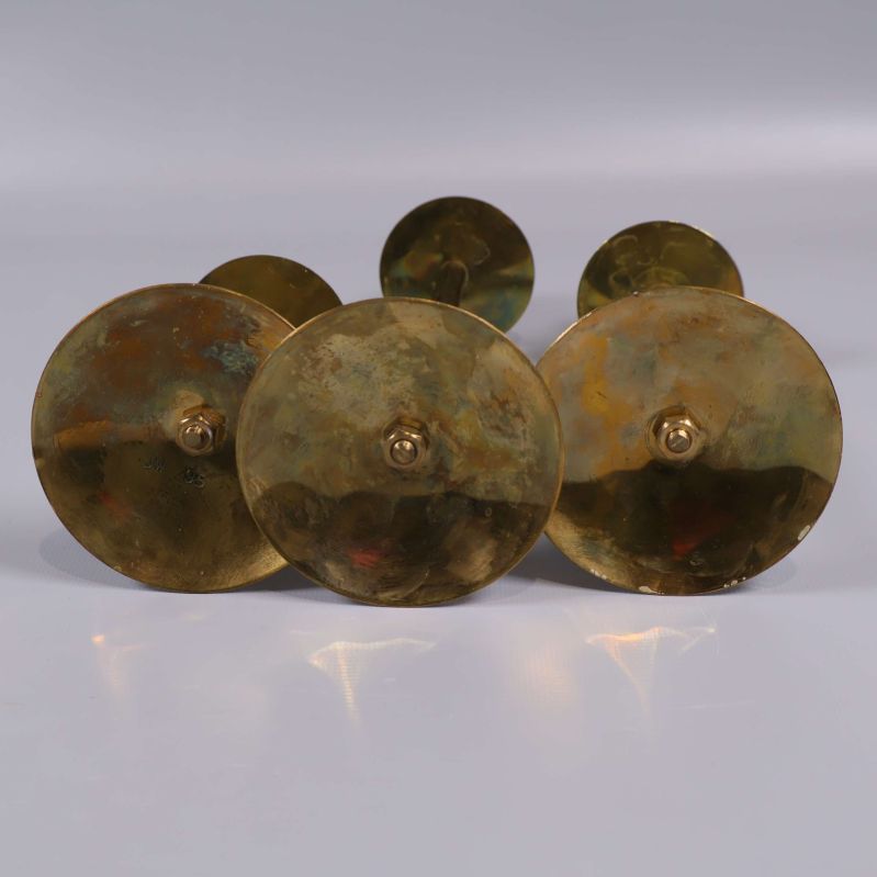 Undersida på ljusstakar med patina och mässingsskruvar