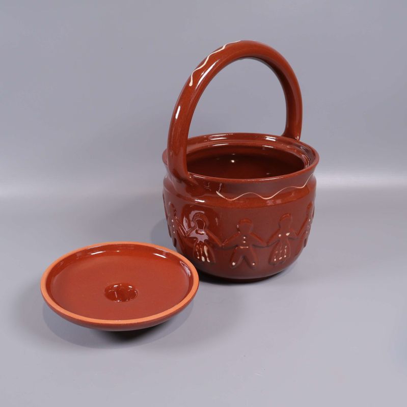 Keramikburk med locket avtaget bredvid burken