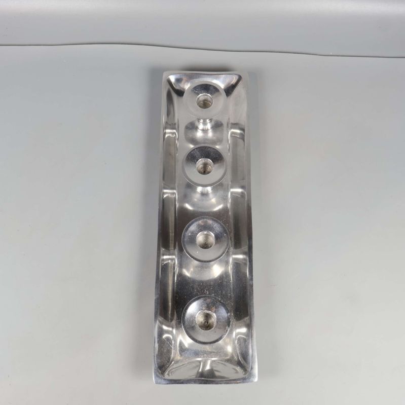 Rektangulär ljushållare sedd ovanifrån med fyra fästen