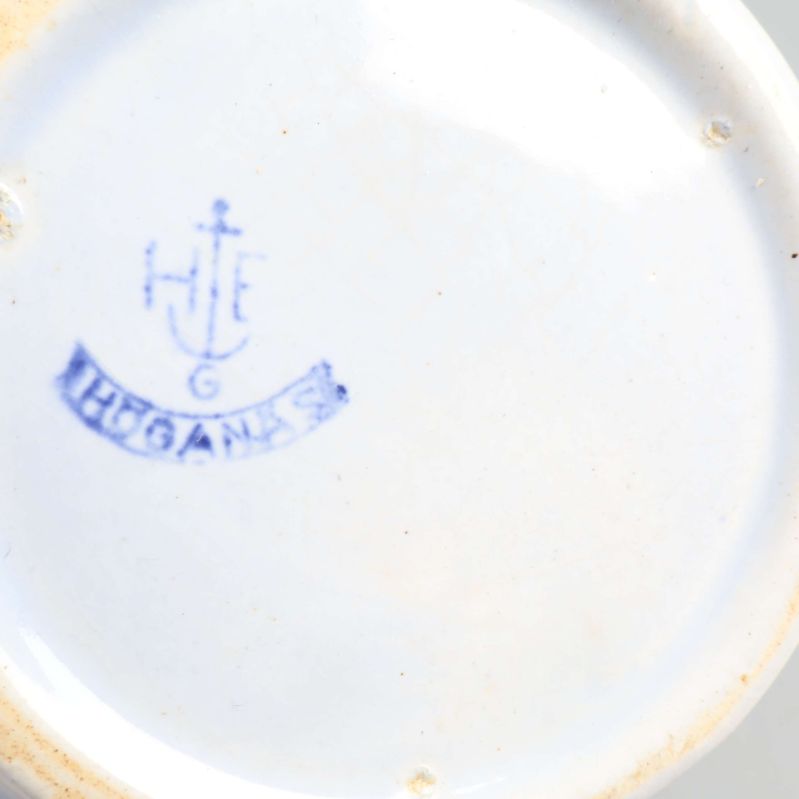 Stämpel med texten Höganäs under en burk