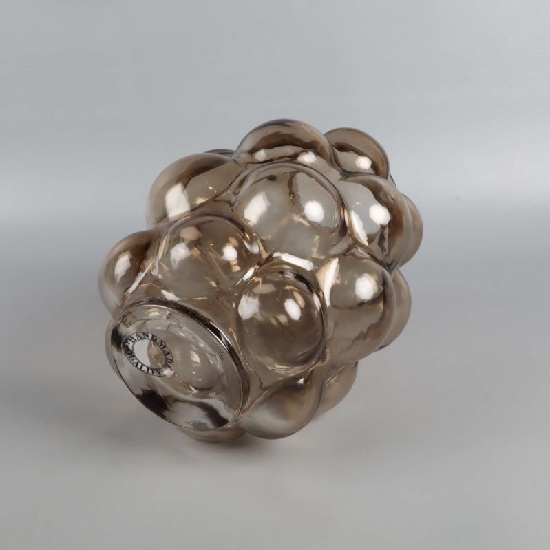 Vas i bubbligt glas liggande på sidan mot ljus bakgrund