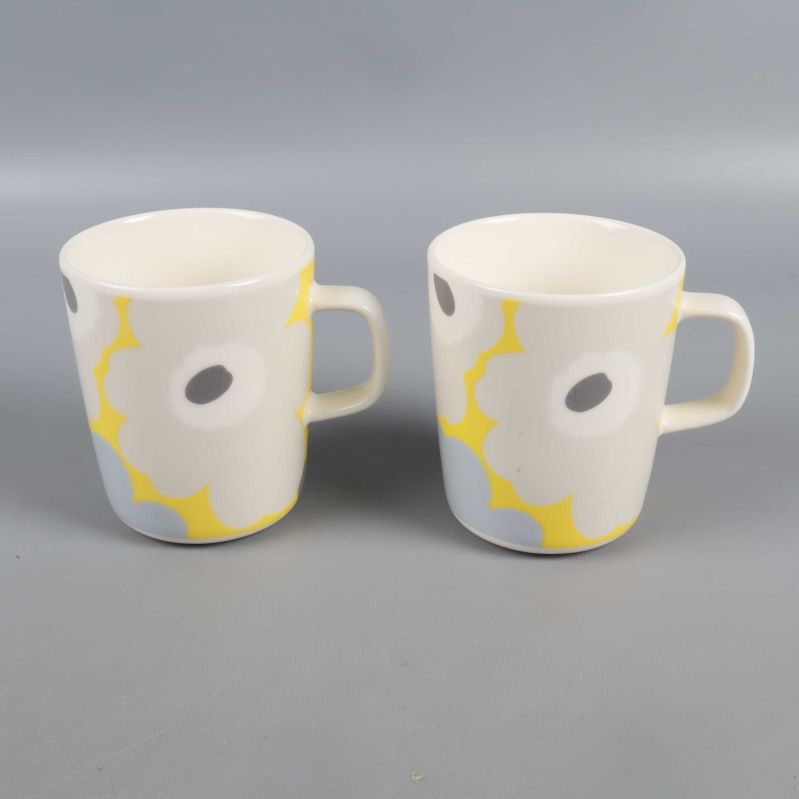 Två Marimekko-koppar från sidan, blommönster synligt