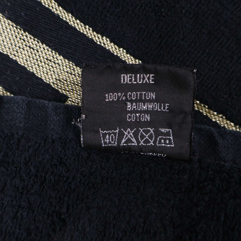 Tvättetikett som visar materialet 100% bomull