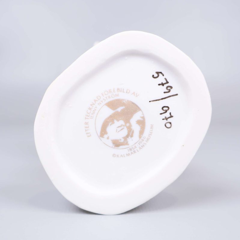 Stämpel under tomtefigur med serienummer och Jenny Nyström-bild