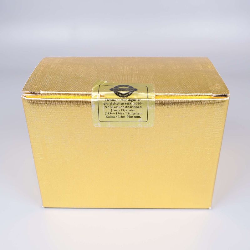 Guldfärgad förpackning med etikett för porslinsfiguren