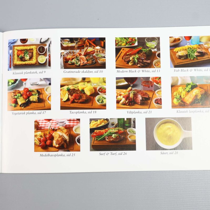 Receptbok med olika maträtter på plankor