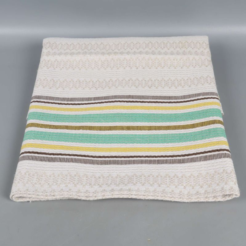 Hopvikt duk med gröna, gula och bruna ränder på ljus botten