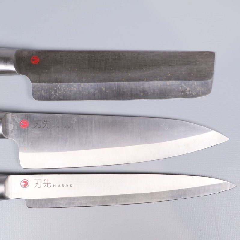 Närbild på knivblad med Hasaki-logo och japansk text