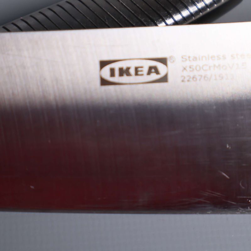 Närbild på IKEA-logga och stålmärkning på knivblad