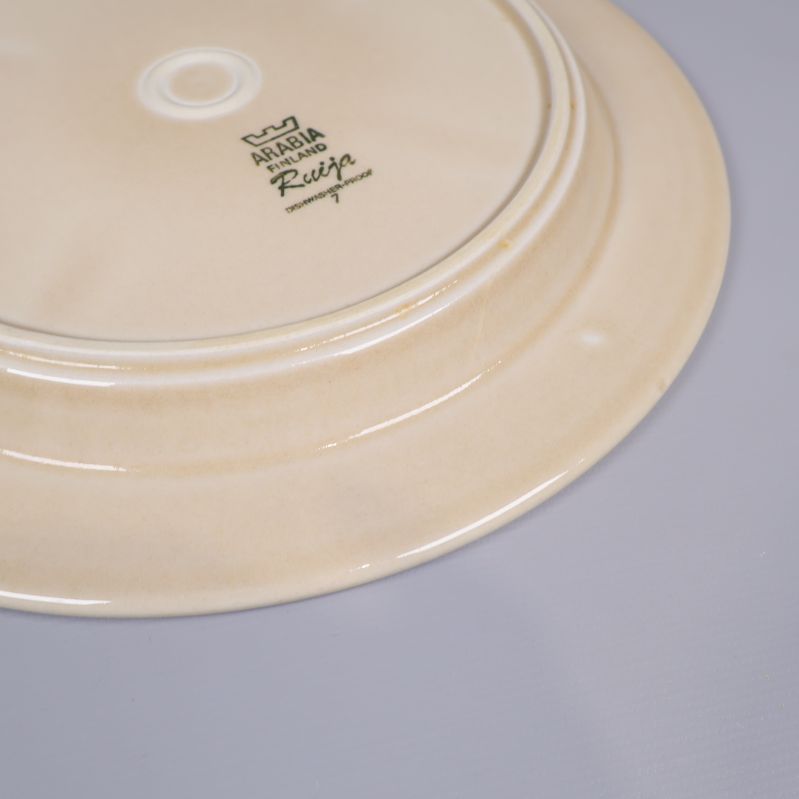 Närbild på klassisk baksida i beige porslin med märkning