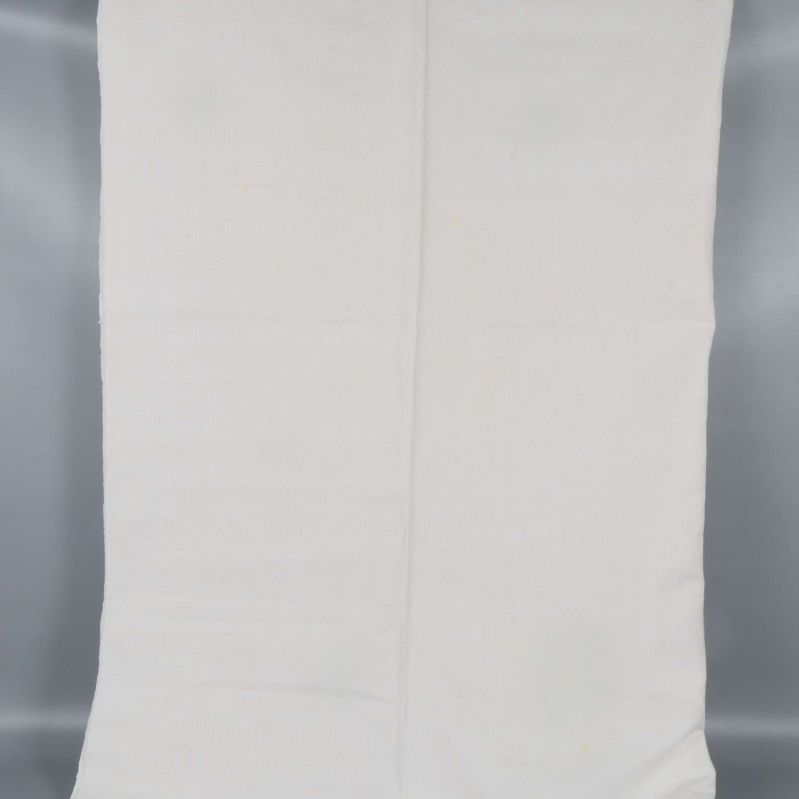 Gräddvit duk utvikt i sin helhet mot grå bakgrund