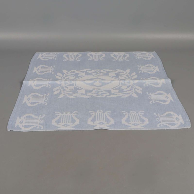 Utvecklad linneservett som visar vävt mönster i sin helhet