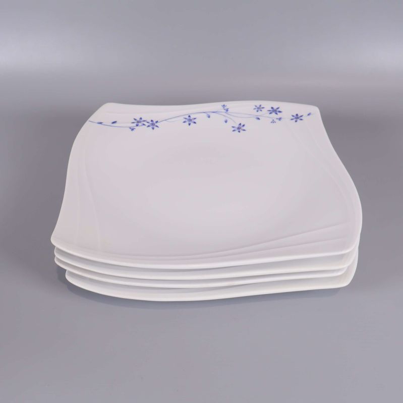 Staplade fyrkantiga tallrikar i vitt med blå blomdekor