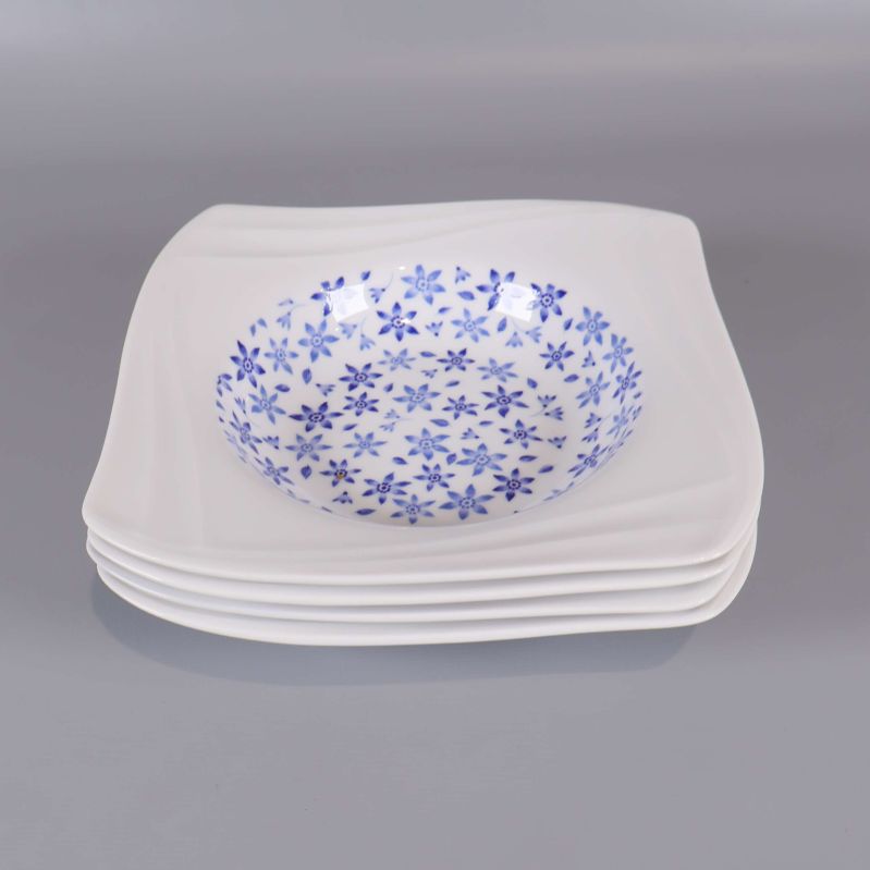 Fyra staplade djupa tallrikar med blåa blommor