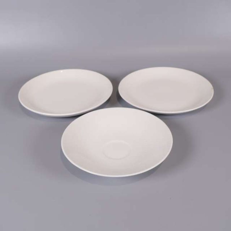 Tre vita porslinsfat placerade bredvid varandra