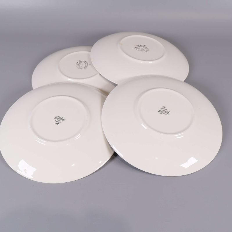 Baksidan av fyra assietter med Rörstrand-stämpel