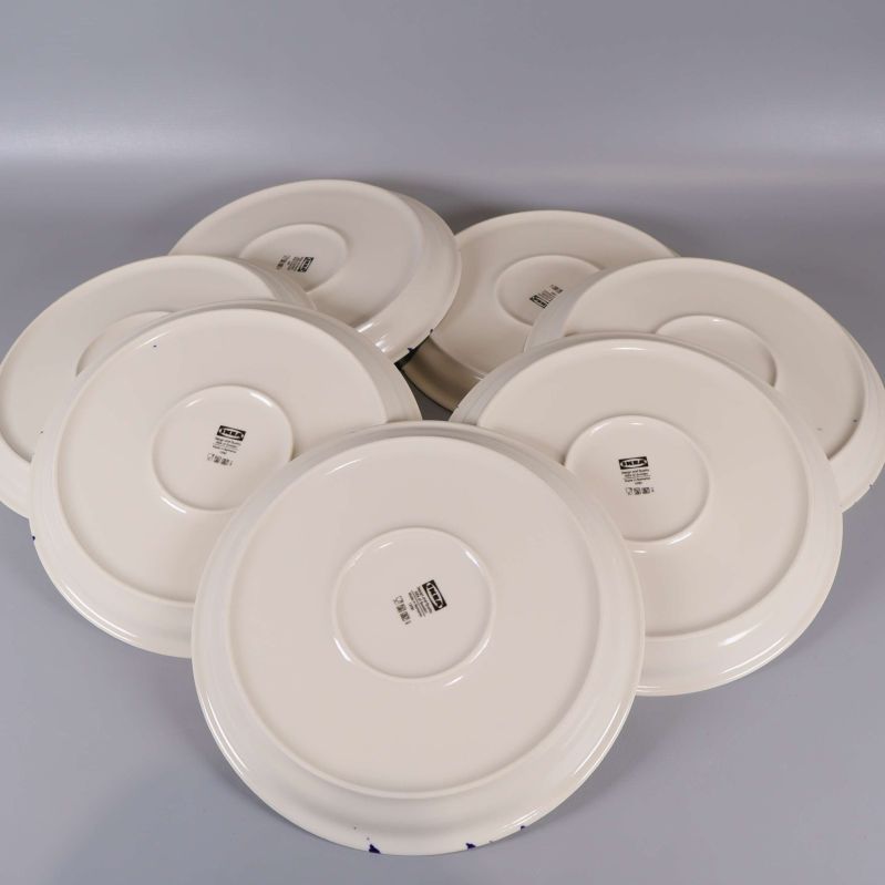 Baksida på flera tallrikar, stämplar och märkning synlig