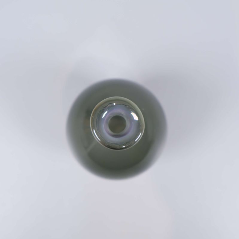 Öppningen på den grågröna glasvasen syns ovanifrån