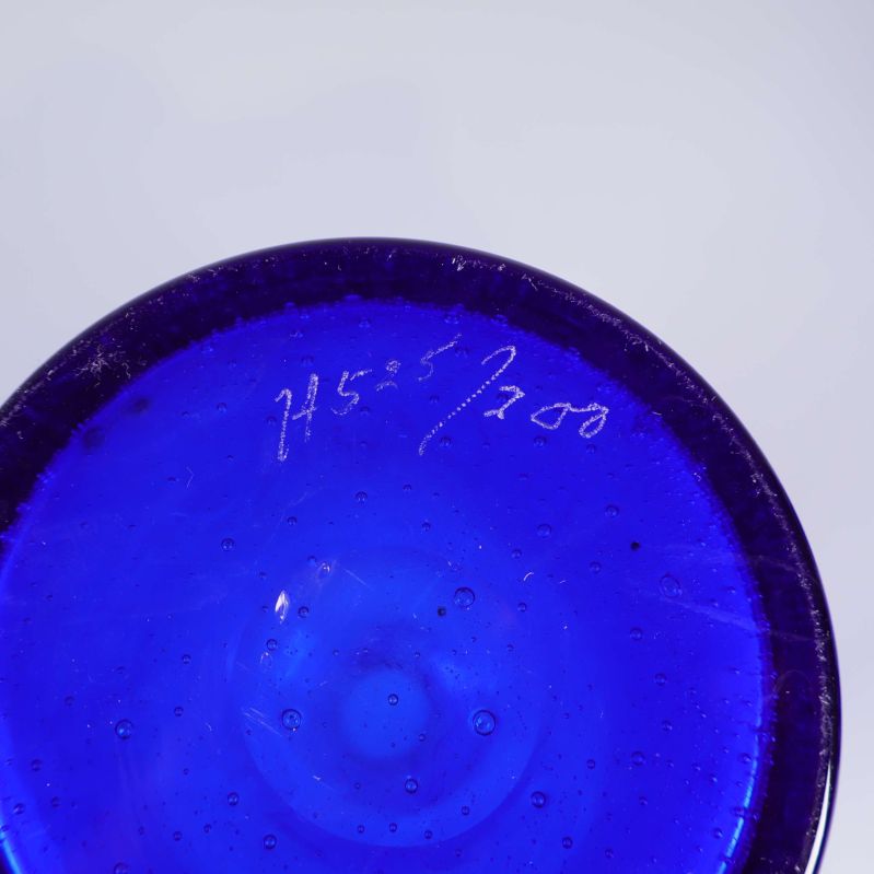 Botten av blå glasvas med ingraverad märkning