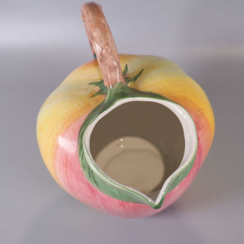 Keramikkanna uppifrån visar bred öppning och grön dekor