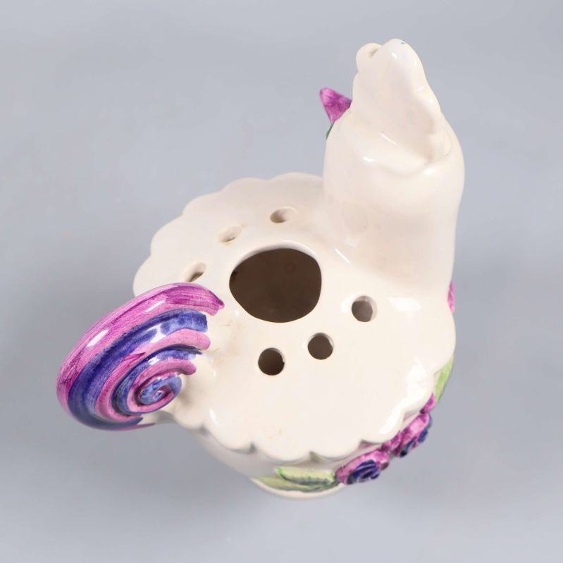 Keramisk kyckling sedd snett ovanifrån från svansen