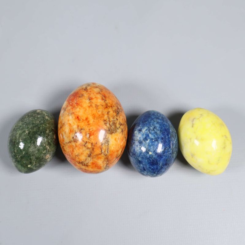 Stenägg i grön, orange, blå och gul färg uppradade